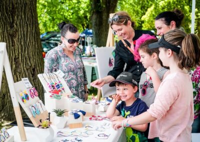 A family looks at craft for sale at an outdoor market