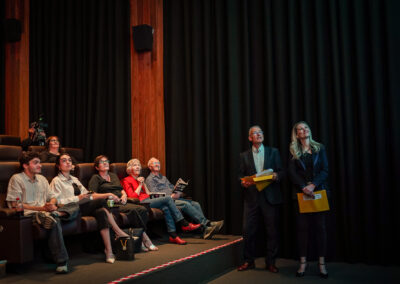 The filmmakers and audience watching in awe of the short film on the screen