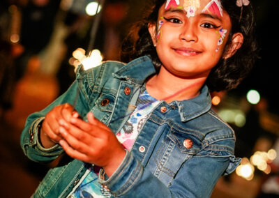 Young girl celebrating the occasion with face paint and sparklers