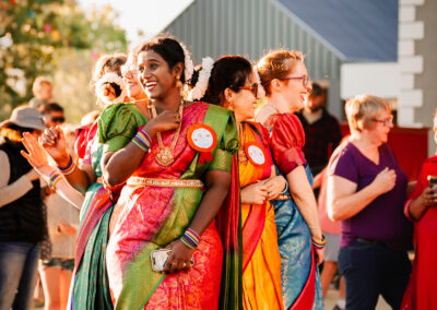 Young Women dressing up in their cultural clothing and dancing in the centre of the mural
