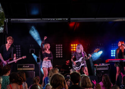Band playing on stage late in the evening.