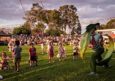 children dancing under the sunset at the festival