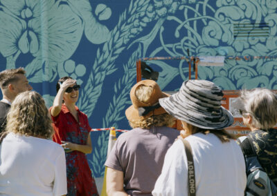 Aurora chatting to a group of people on a street art tour